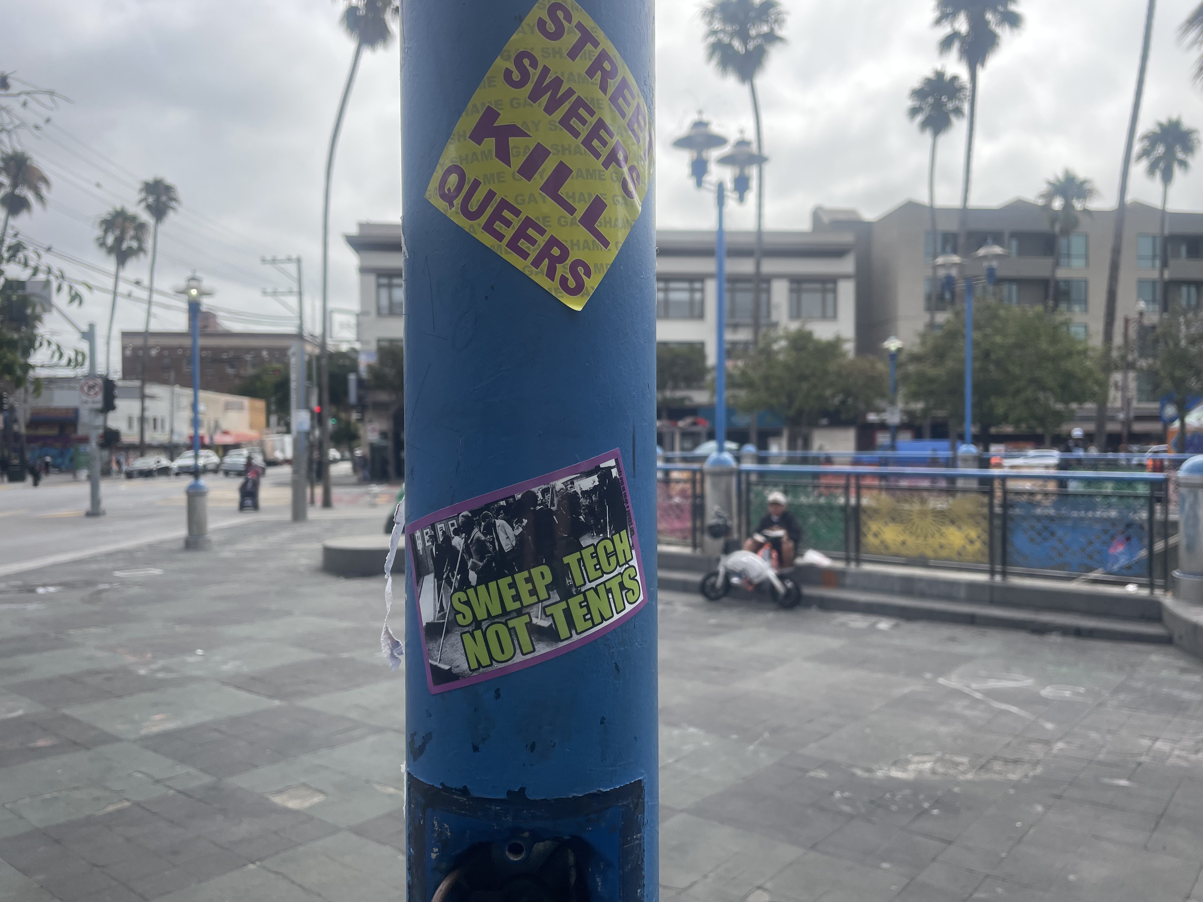 Sticker graffiti protesting police sweeps targeting unhoused people, near the Sixteenth Street / Mission BART transit station in San Francisco. Photo: Eric A. Stanley.
