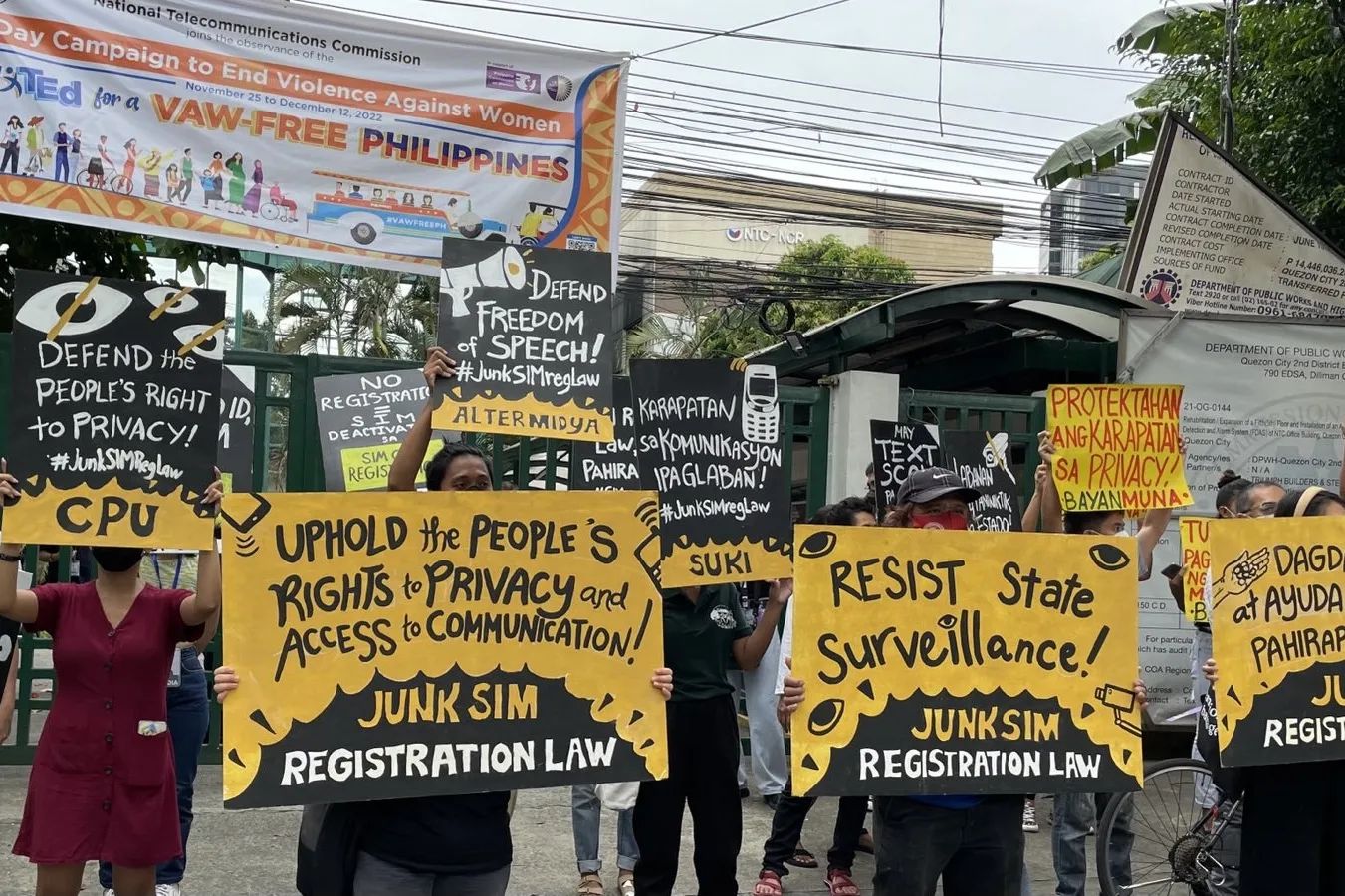 Photo is of protestors against the SIM registration law. Protestors' signs say in English: "Defend freedom of speech!" "Uphold the People's rights to privacy and access to communication!" "Resist state surveillance!" 