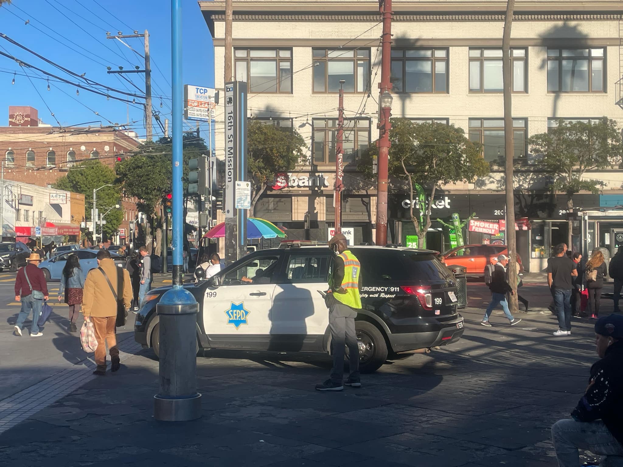 An SFPD cruiser parked near the entrance to the Sixteenth Street / Mission BART transit station in San Francisco. Photo: Eric A. Stanley.