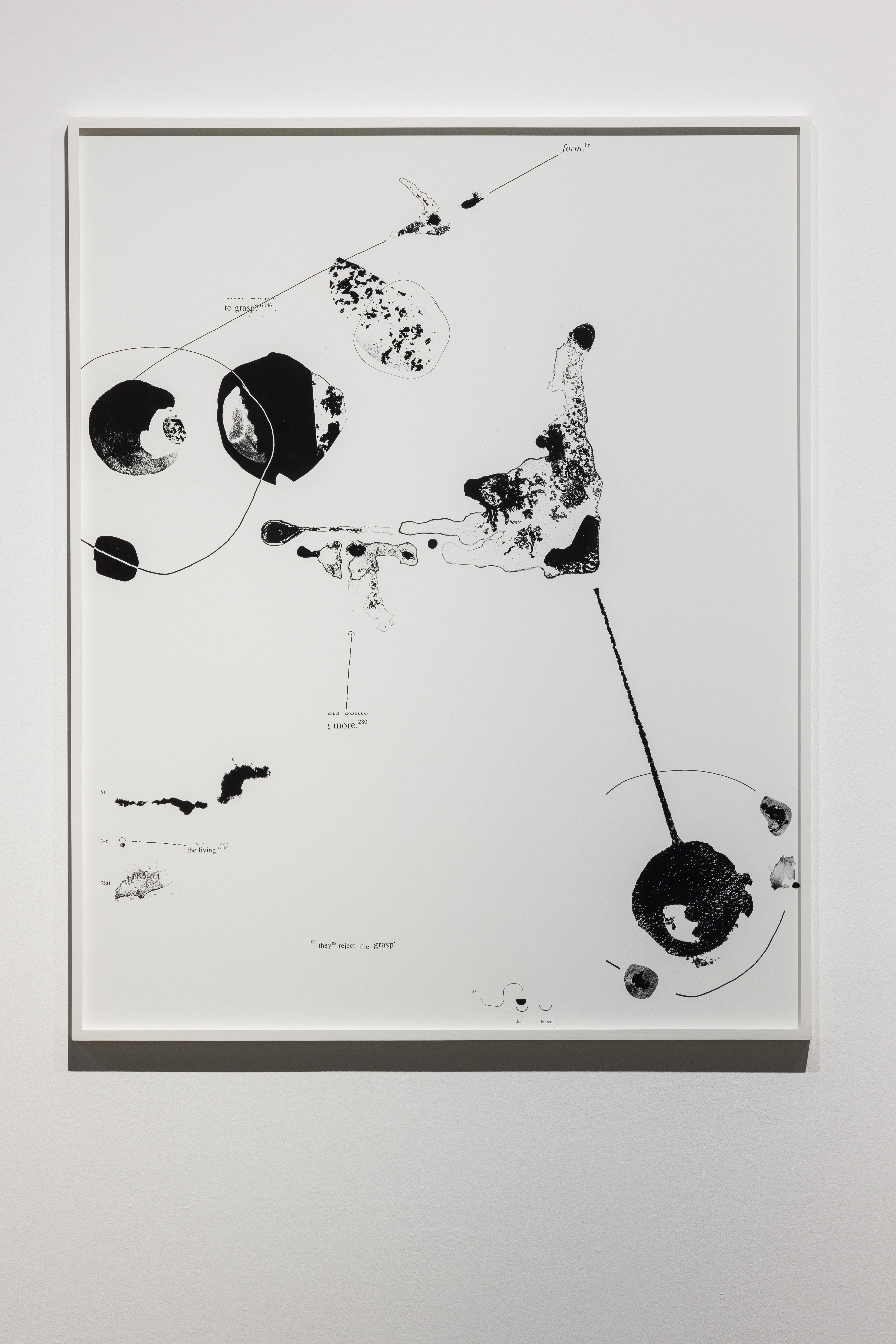A framed, mostly white collage contains scattered black circular and irregular forms, fine connecting lines, and small annotations, leaving broad areas of empty space.