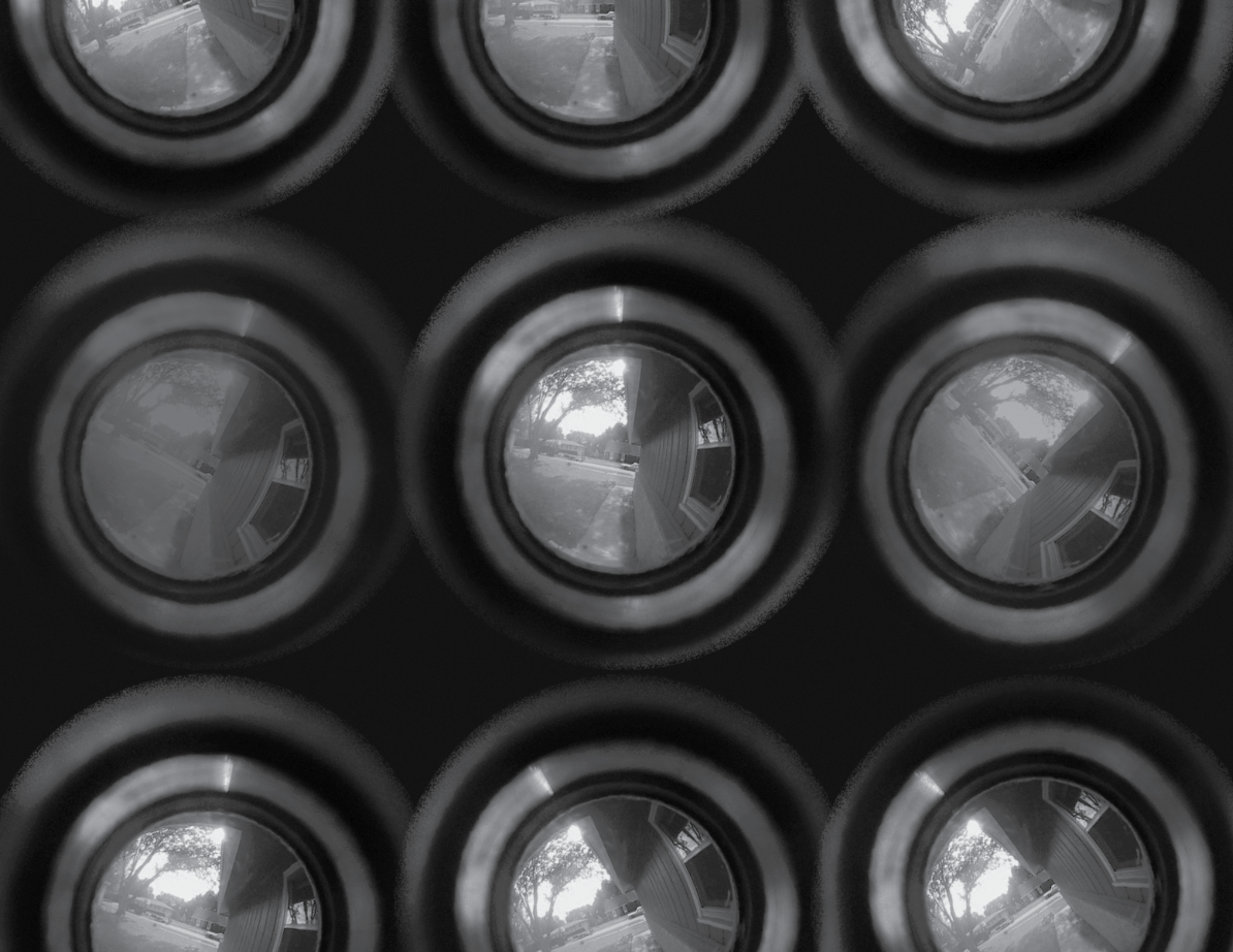 An abstract image of bubbles that look like frog eggs, which contain a scene that appears to be a view out a peephole